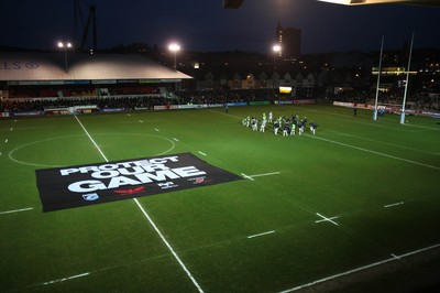 261213 - Newport Gwent Dragons v Cardiff Blues, RaboDirect PRO12 - A protest banner is placed on the pitch before the start of the match