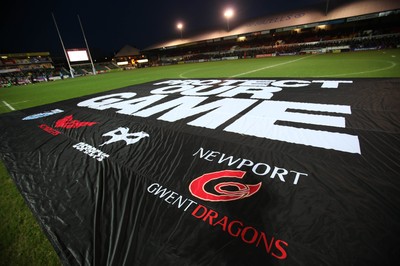 261213 - Newport Gwent Dragons v Cardiff Blues, RaboDirect PRO12 - A protest banner is placed on the pitch before the start of the match