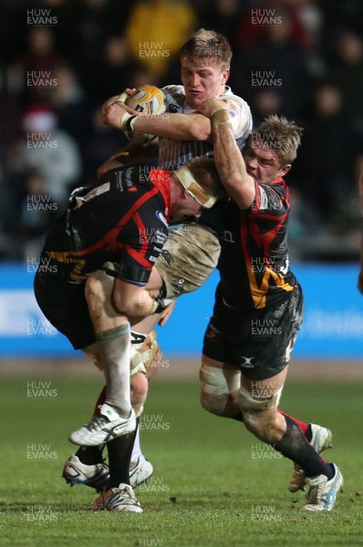 261213 - Newport Gwent Dragons v Cardiff Blues, RaboDirect PRO12 - Blues' Macauley Cook is tackled by Dragons Andrew Coombs and Dragons Lewis Evans