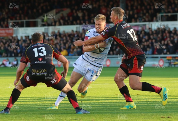 061018 - Dragons v Cardiff Blues, Guinness PRO14 - Gareth Anscombe of Cardiff Blues is tackled by Jarryd Sage of Dragons