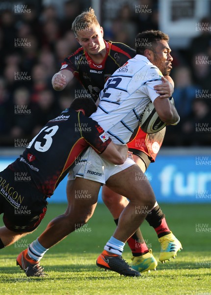 061018 - Dragons v Cardiff Blues, Guinness PRO14 - Willis Halaholo of Cardiff Blues is tackled by Jarryd Sage of Dragons and Adam Warren of Dragons