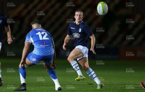 070918 - Dragons A v Cardiff Blues A - Celtic Cup - Ben Jones of Cardiff Blues chips the ball past Connor Edwards of Dragons