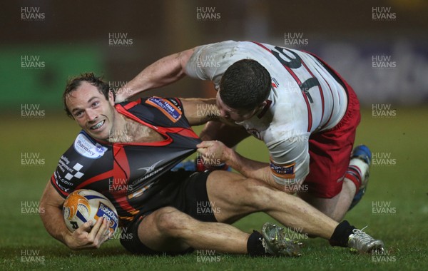 030414 - Newport Gwent Dragons v Edinburgh, RaboDirect PRO12 - Dragons' Will Harries is tackled by Edinburgh's James Hilterbrand