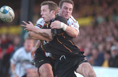 080105 - Newport Gwent Dragons v Edinburgh - Celtic League - Dragon's Kevin Morgan is tackled by Brendan Laney