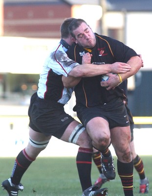 080105 - Newport Gwent Dragons v Edinburgh - Celtic League - Dragon's Adam Black is tackled David Callam