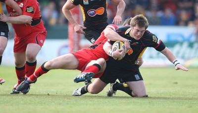 18.04.10 ... Newport Gwent Dragons v Edinburgh - Magners League -  Dragons' Hugh Gustafson is tackled 