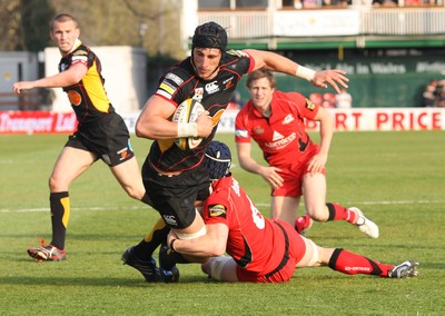 18.04.10 ... Newport Gwent Dragons v Edinburgh - Magners League -  Dragons' Luke Charteris is tackled by Edinburgh's Alan MacDonald 