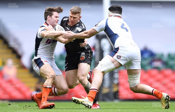 280321 - Dragons v Edinburgh - Guinness PRO14 - Jack Dixon of Dragons is tackled by Chris Dean and Marshall Sykes of Edinburgh