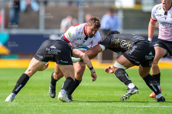 210522 - Dragons v Emirates Lions - United Rugby Championship - Ruan Dreyer of Emirates Lions is tackled by Aki Seiuli of Dragons and Ollie Griffiths of Dragons
