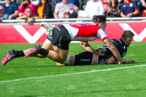 210522 - Dragons v Emirates Lions - United Rugby Championship - Josh Lewis of Dragons is tackled by Quan Horn of Emirates Lions