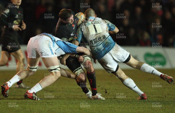 150213 - Newport Gwent Dragons v Glasgow, RaboDirect PRO12 - Dragons Adam Jones is tackled by the Glasgow defence   