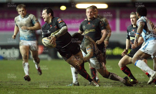 150213 - Newport Gwent Dragons v Glasgow, RaboDirect PRO12 - Dragons Dan Evans looks to feed the ball out as he's tackled    