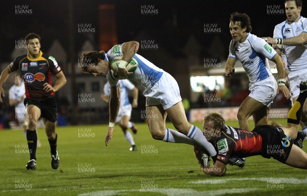 16.10.09 - Newport Gwent Dragons v Glasgow Warriors, Heineken Cup -  Glasgow's Thom Evans is tackled by Dragons' Ashley Smith 