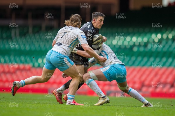 210321 - Dragons v Glasgow Warriors - Guinness PRO14 - Sam Davies of Dragons is tackled by Robbie Ferguson of Glasgow Warriors and Thomas Gordon of Glasgow Warriors