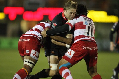 04.11.10..Newport Gwent Dragons v Gloucester, LV= Cup - Dragons Lewis Evans is tackled by Gloucester's Lesley Vainikolo and Akapusi Qera 