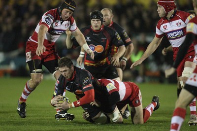 04.11.10..Newport Gwent Dragons v Gloucester, LV= Cup - Dragons Adam Jones is brought down 