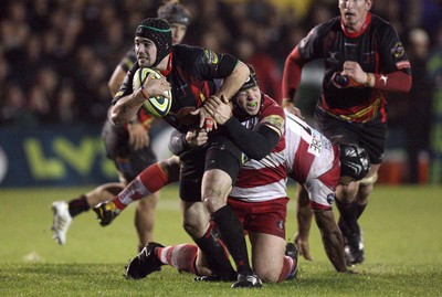 04.11.10..Newport Gwent Dragons v Gloucester, LV= Cup - Dragons Adam Hughes is tackled by Alasdair Dickinson 