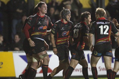 04.11.10..Newport Gwent Dragons v Gloucester, LV= Cup - Dragons Robin Sowden-Taylor (centre) is congratulated by teammates after scoring try 