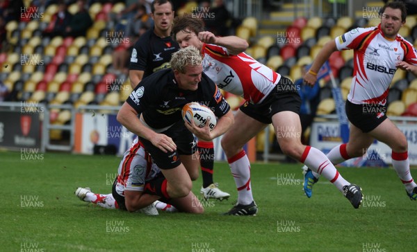 040812 - Newport Gwent Dragons v Gwent Select XV, Pre-season Friendly - Dragons Pat Leach is tackled by Gwent's Alan Awcock and Gwent's Geraint O'Driscoll          