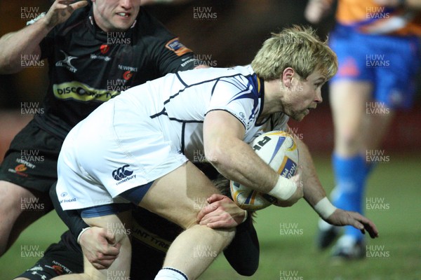 010313 - Newport Gwent Dragons v Leinster, RaboDirect PRO12 - Leinster's Fionn Carr looks for support as he's tackled by the Dragons defence 