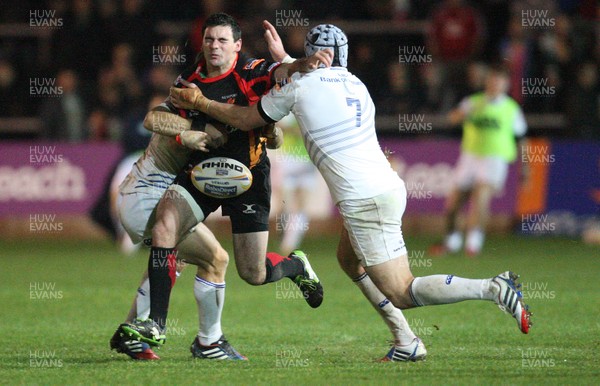 011113 - Newport Gwent Dragons v Leinster, RaboDirect PRO12 - Dragons Adam Hughes is tackled by Leinster's Jimmy Gopperth and Shane Jennings