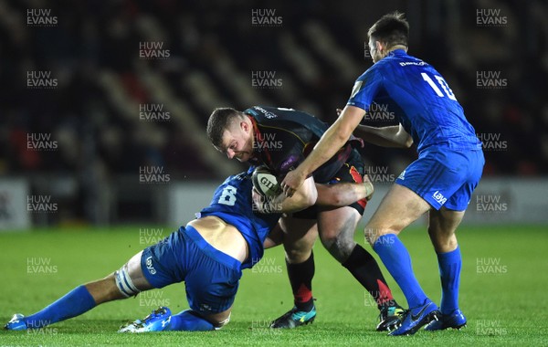 011218 - Dragons v Leinster - Guinness PRO14 - Lloyd Fairbrother of Dragons is tackled by Caelan Doris and Ross Byrne of Leinster