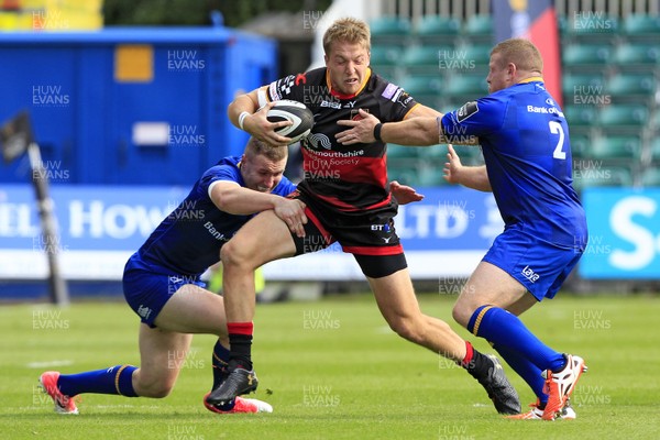 020917 - Dragons v Leinster, Guinness Pro 14 - Tyler Morgan of Dragons (centre) fends off Sean Cronin of Leinster (right)
