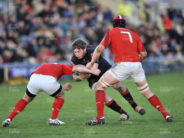 190413 - Newport Gwent Dragons v Munster - RaboDirect PRO12 -  Dragons Hugh Gustafson, centre, is tackled by Munster's Ian Keatley, left, and Niall Ronan