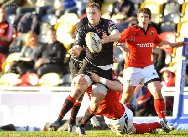 190413 - Newport Gwent Dragons v Munster - RaboDirect PRO12 -  Dragons Lewis Robling releases the ball whilst being tackled