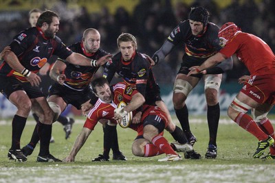 26.11.10...Newport Gwent Dragons v Munster, Magners League -  Munster's Tomas O'Leary is held by Dragons' Wayne Evans  