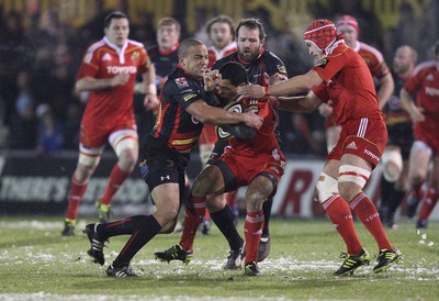 26.11.10...Newport Gwent Dragons v Munster, Magners League -  Munster's Doug Howlett is tackled by Dragons' Gavin Thomas   