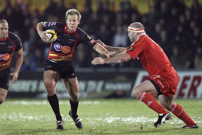 26.11.10...Newport Gwent Dragons v Munster, Magners League -  Dragons' Ashley Smith holds off Munster's John Hayes  