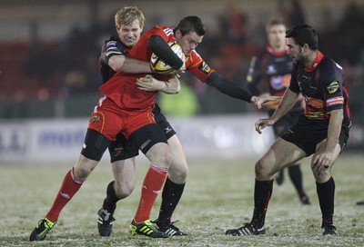 26.11.10...Newport Gwent Dragons v Munster, Magners League -  Munster's Denis Hurley is tackled by Dragons' Patrick Leach   