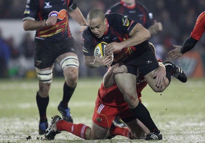 26.11.10...Newport Gwent Dragons v Munster, Magners League -  Dragons' Gavin Thomas  is tackled by Munster's Peter Borlase  