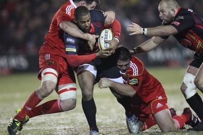 26.11.10...Newport Gwent Dragons v Munster, Magners League -  Dragons' Aled Brew is wrapped up by the Munster defence 