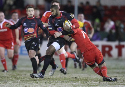 26.11.10...Newport Gwent Dragons v Munster, Magners League -  Dragons' Aled Brew takes on Munster's Scott Deasy  