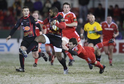 26.11.10...Newport Gwent Dragons v Munster, Magners League -  Dragons' Aled Brew takes on Munster's Scott Deasy  