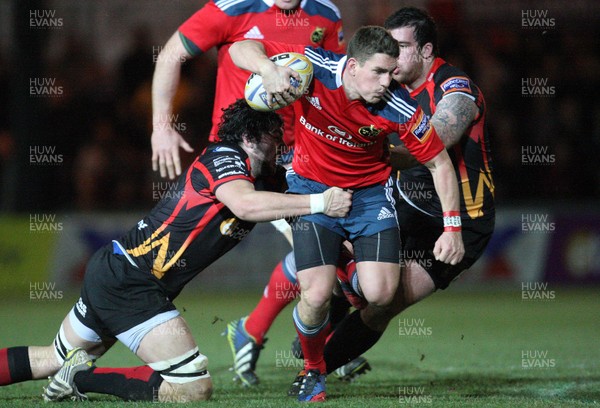 291113 - Newport Gwent Dragons v Munster, RaboDirect PRO12 - Munster's Ian Keatley is tackled by Dragons Cory Hill and Dragons Owen Evans