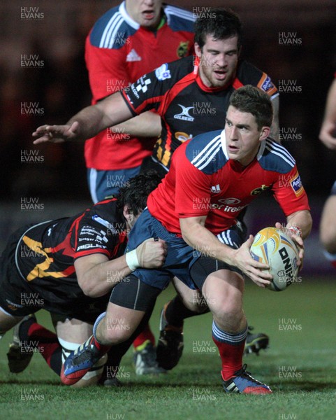 291113 - Newport Gwent Dragons v Munster, RaboDirect PRO12 - Munster's Ian Keatley is tackled by Dragons Cory Hill and Dragons Owen Evans