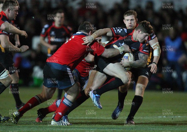 291113 - Newport Gwent Dragons v Munster, RaboDirect PRO12 - Dragons Ross Wardle is tackled by Munster's Dave Kilcoyne