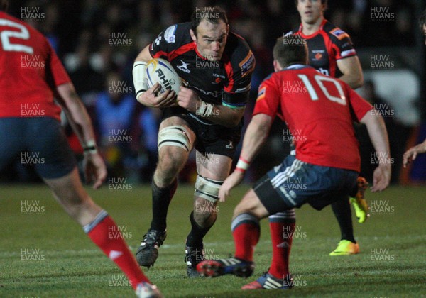 291113 - Newport Gwent Dragons v Munster, RaboDirect PRO12 - Dragons Rob Sidoli takes on Munster's Ian Keatley