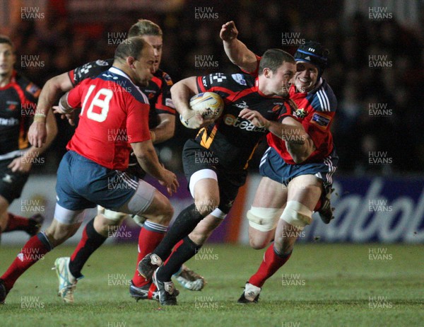 291113 - Newport Gwent Dragons v Munster, RaboDirect PRO12 - Dragons Richie Rees gets past Munster's Barry O'Mahony