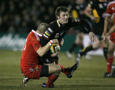 06.02.10 Dragons v Munster... Dragons' Martyn Thomas is tackled by Munster's Paul Warwick. 