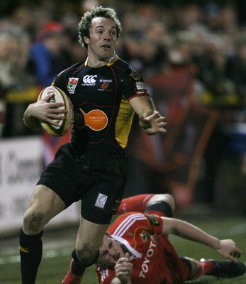 06.02.10 Dragons v Munster... Dragons' Will Harries beats Munster's Denis Hurley. 