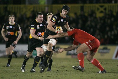 06.02.10 Dragons v Munster... Dragons' Luke Charteris is tackled by Munster's Tony Buckley. 