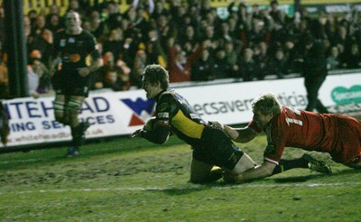 06.02.10 Dragons v Munster... Dragons' Martyn Thomas  scores try despite tackle by Munster's Jean De Villiers. 