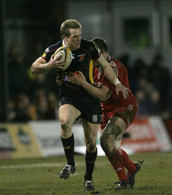 06.02.10 Dragons v Munster... Dragons' Matthew Watkinsis tackled by Munster's Tommy O'Donnell. 