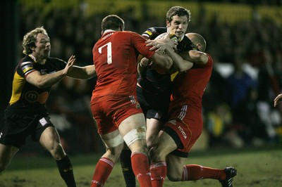 06.02.10 Dragons v Munster... Dragons' Jason Tovey is tackled by Munster's Tommy O'Donnell and Paul Warwick. 