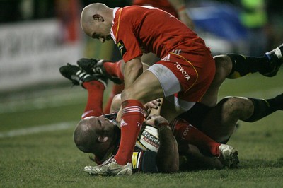 06.02.10 Dragons v Munster... Dragons' Tom Willis is tackled by Munster's Peter Stringer. 