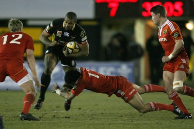 06.02.10 Dragons v Munster... Dragons' Aled Brew  is tackled by Munster's Lifeimi Mafi. 